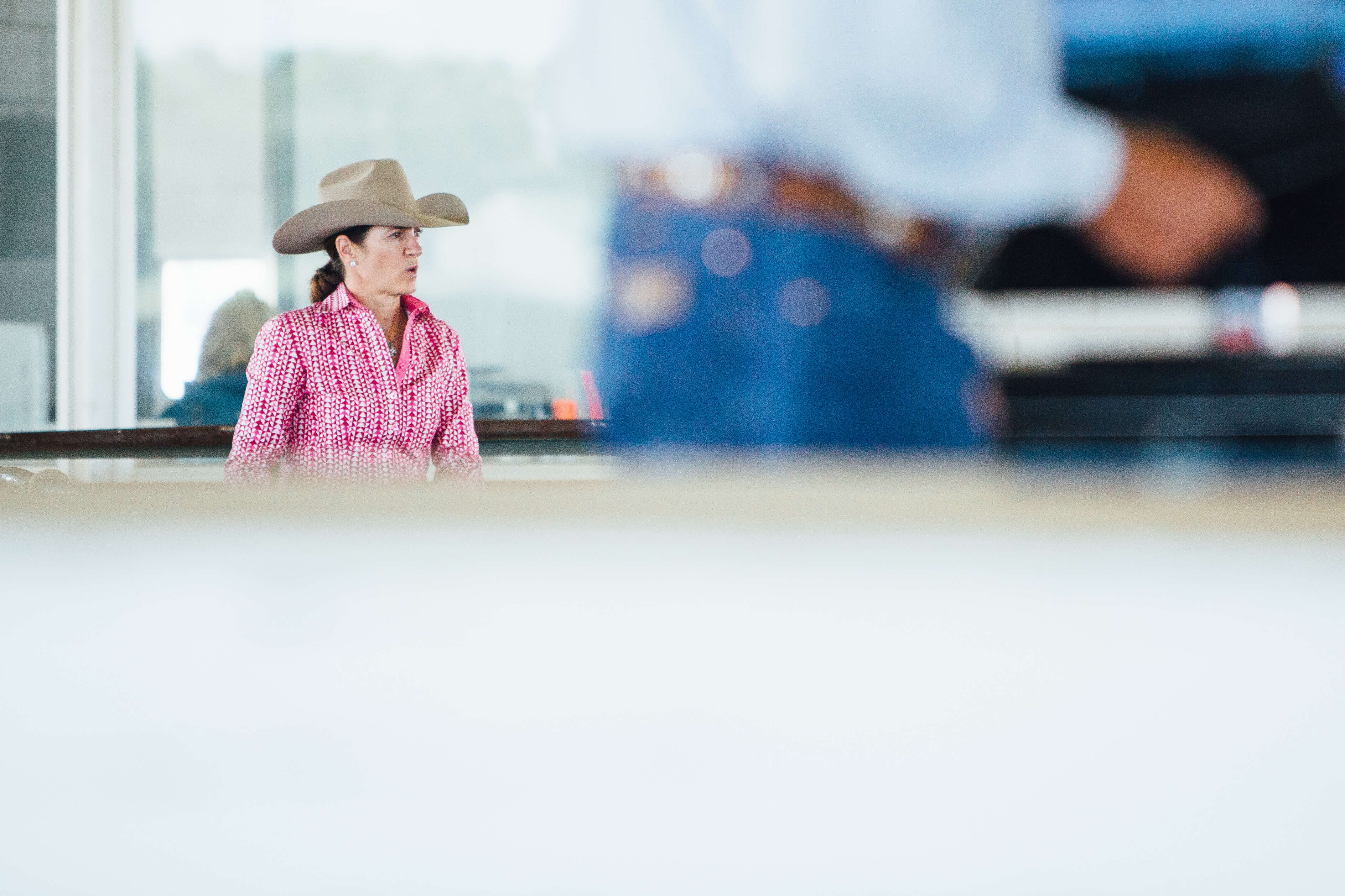 cowgirl watching cutting competition