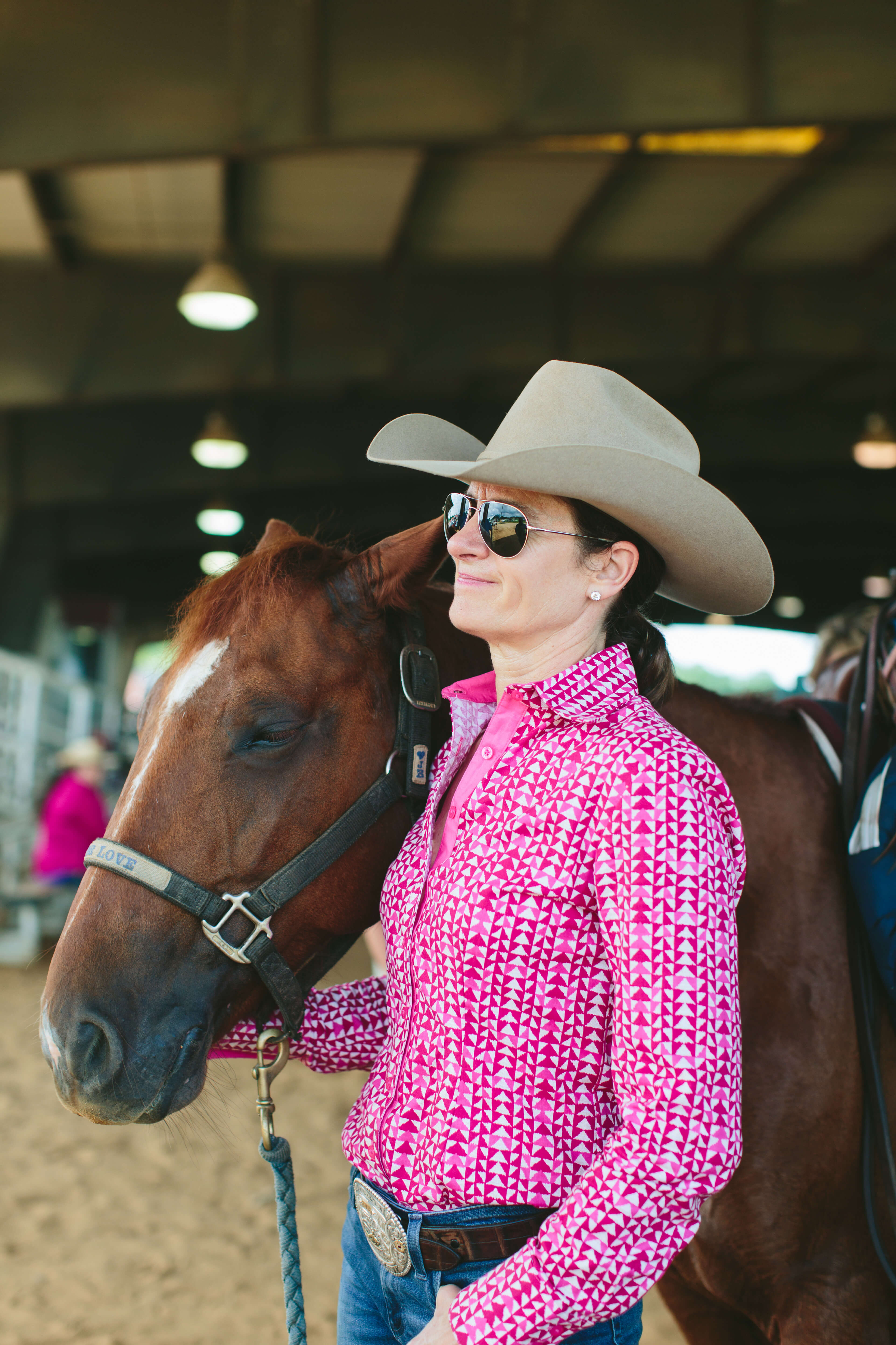 cowgirl in sunglasses with horse