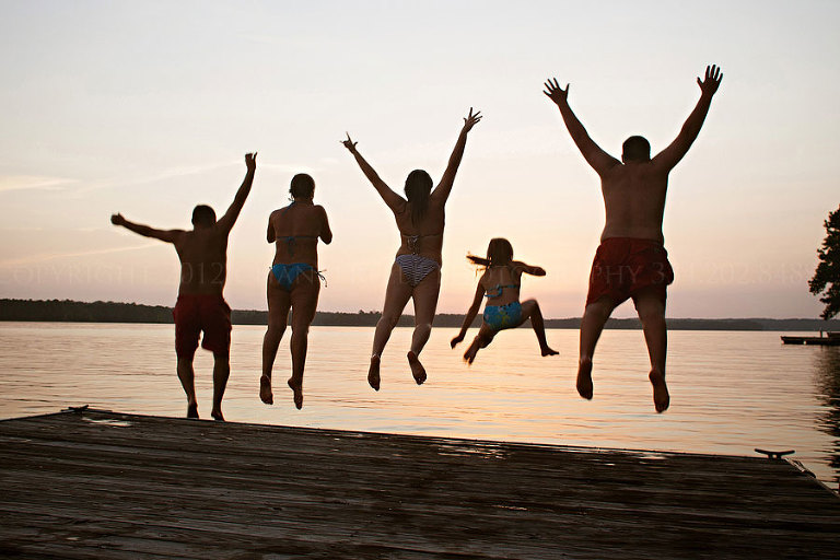 a family jumping into lake martin