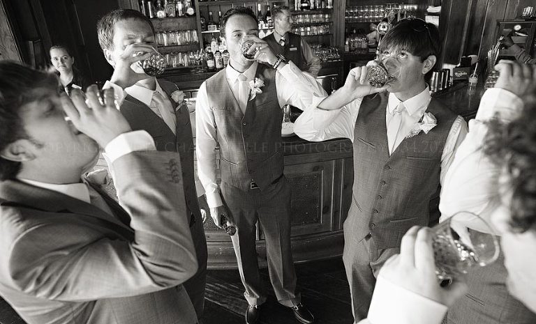 groomsmen doing shots at a charleston south carolina wedding