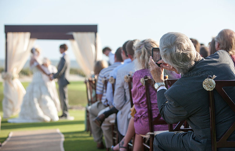 guest taking a picture with his iphone at a kiawah island wedding