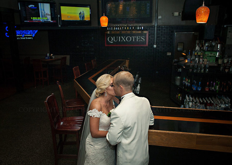 a bride and groom at the bar where they met in auburn alabama
