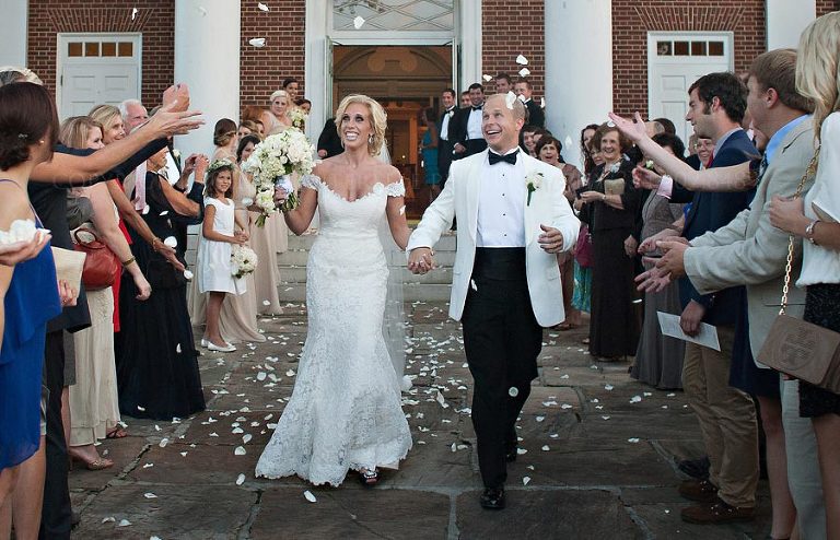 bride and groom exit in a shower of rose petals from auburn united methodist church