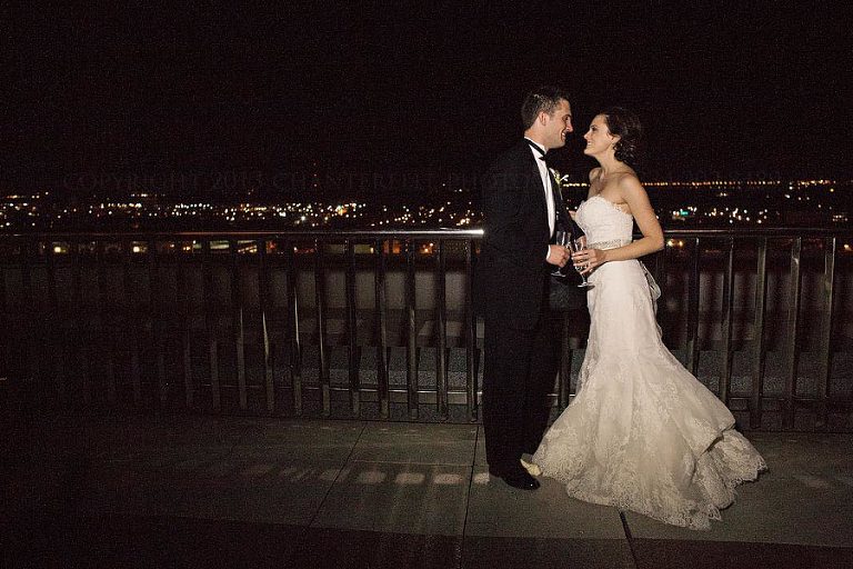 bride and groom overlooking downtown montgomery alabama at night