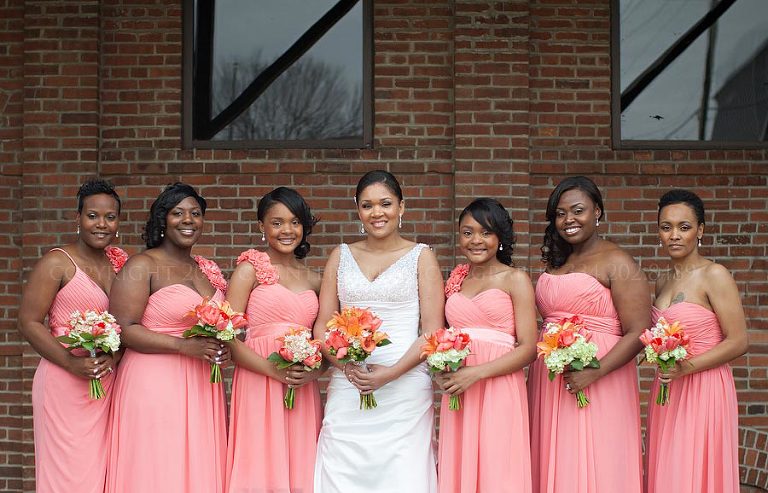 bride and bridesmaids in salmon dresses