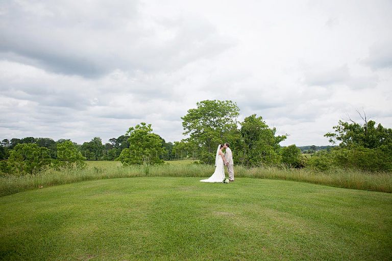 bride and groom in a field at the oaks plantation