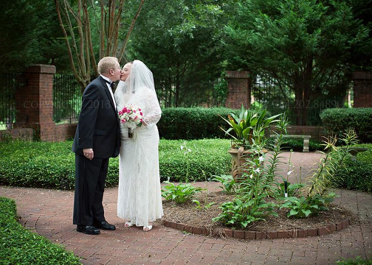 bride and groom in courtyard at st joseph of arimathea