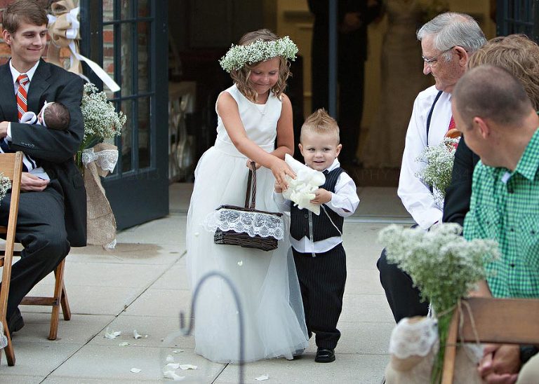flowergirl and ringbearer walking down the aisle at alley station