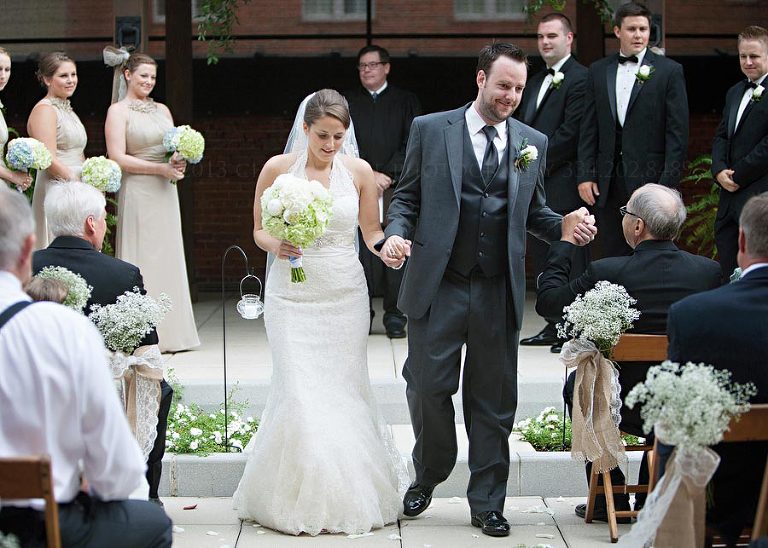 bride and groom exit their alley station rooftop ceremony