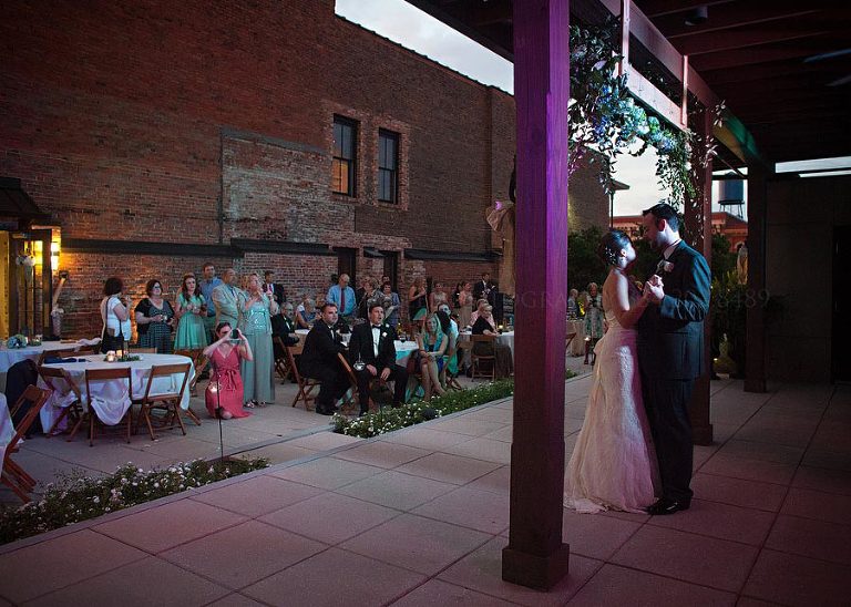 bride and groom first dance at alley station rooftop