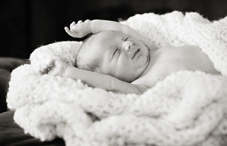 newborn baby stretching during portrait session in montgomery