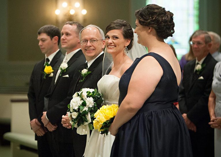 bride looks at her sister and maid of honor during her opelika ceremony