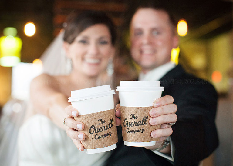 bride and groom with overall company coffee cups