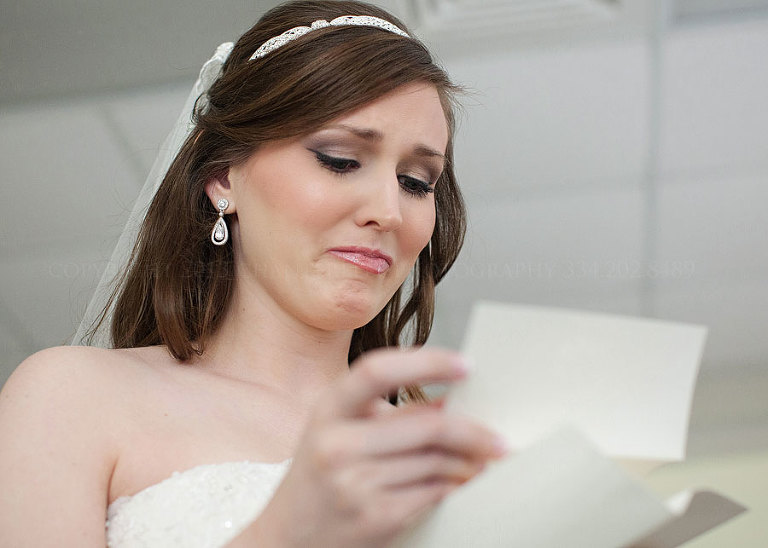 bride crying reading a letter from the groom in alabama