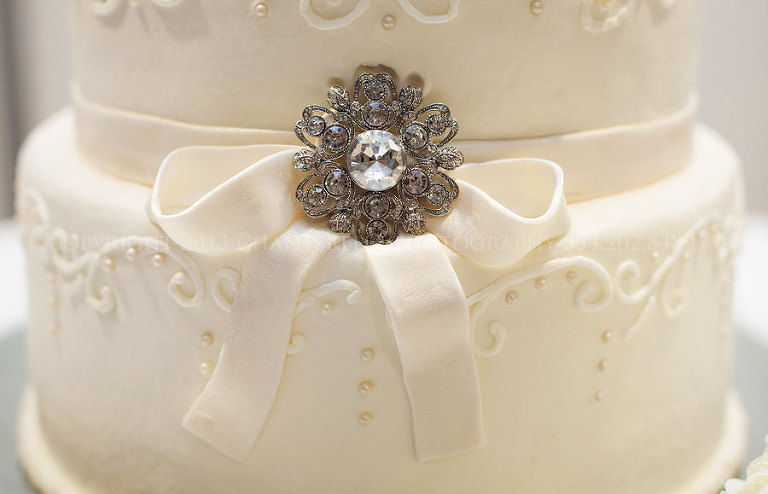 brides cake with brooch at a troy university wedding