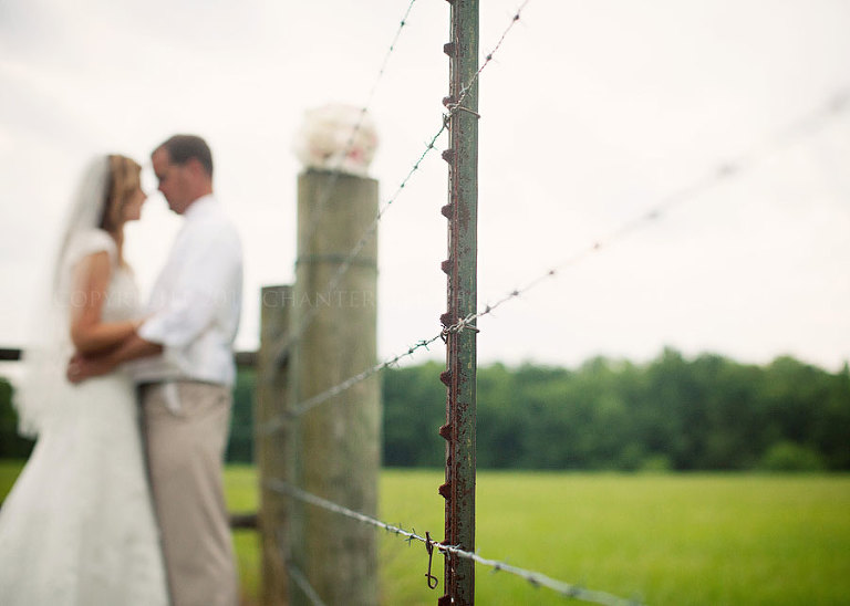 bride and groom with barbed wire on a farm in pike road