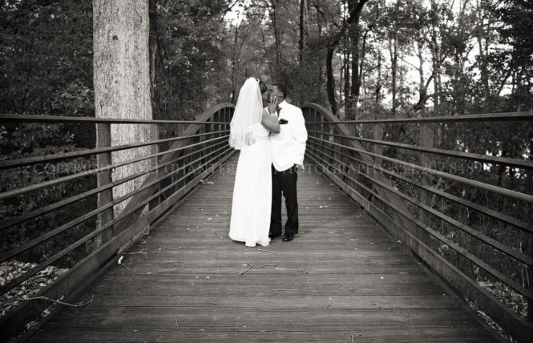 bride and groom on a bridge at gold star park