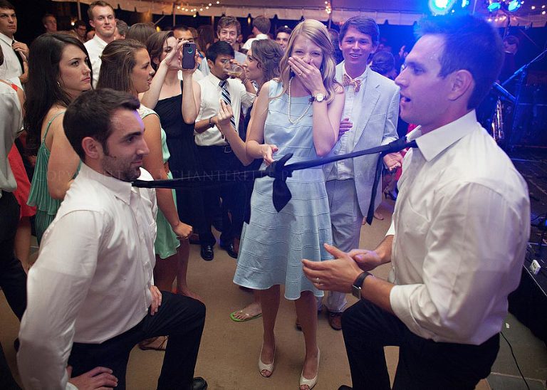 groomsmen with neckties tied together for limbo