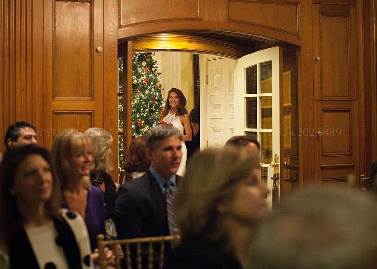 bride peeking down the aisle at an auburn alabama wedding