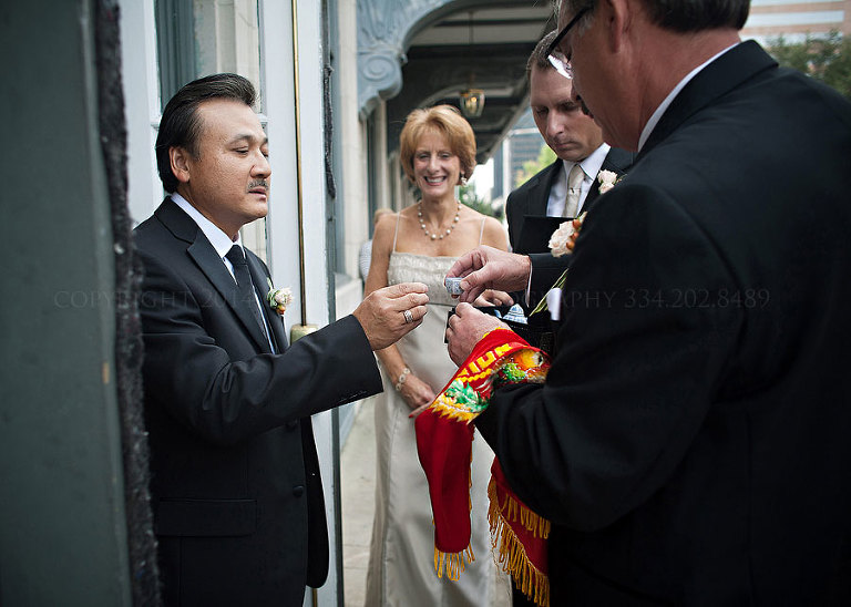 father of the bride greeting grooms family before vietnamese tea ceremony