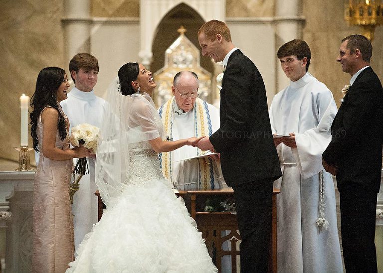 bride laughing during catholic wedding ceremony