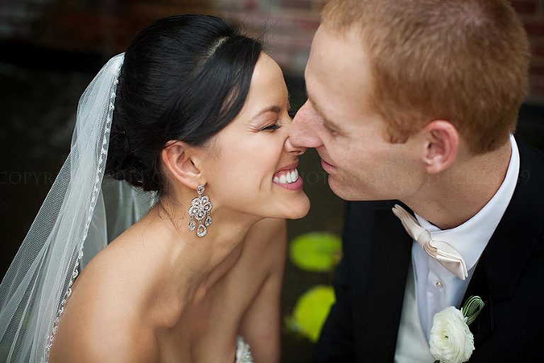pretty asian bride smiling at groom