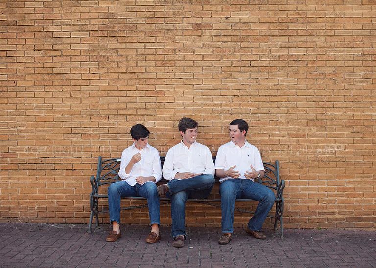 portrait of three brothers on a bench
