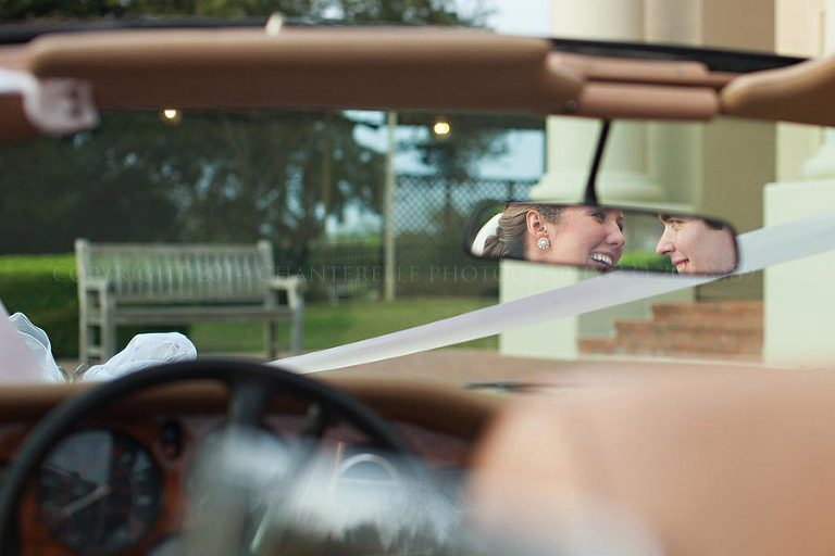 bride and groom in rearview mirror outside montgomery country club