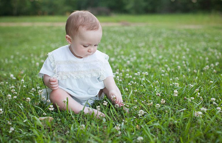 baby picking flowers