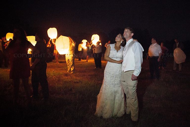 bride and groom watching wish lanterns at prattville wedding
