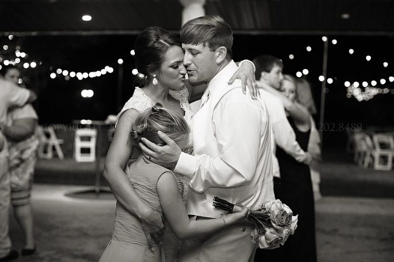 bride and groom dance with groom's daughter at alabama wedding