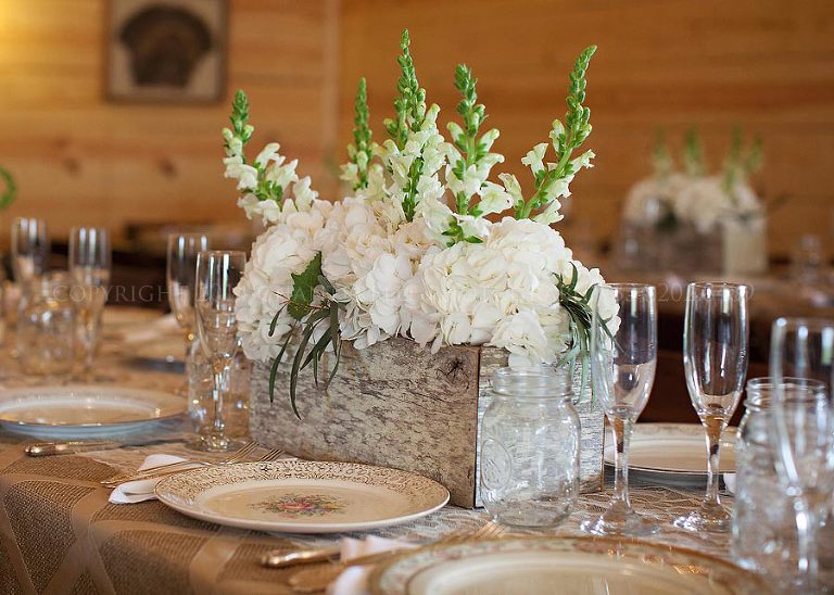 centerpieces in weathered wood boxes at barn wedding reception