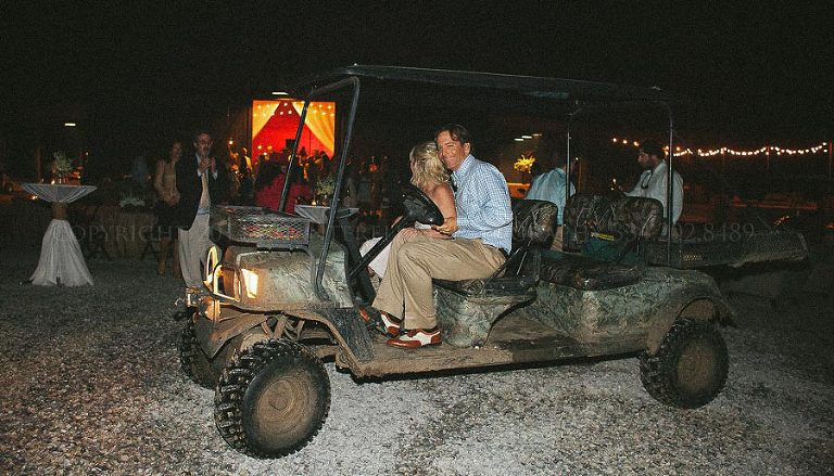 bride and groom leave in camouflage mule