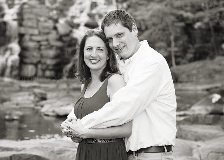 black and white portrait in front of a waterfall