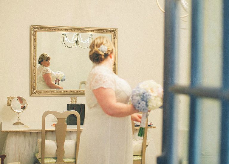 bride getting ready to walk down the aisle at barn wedding