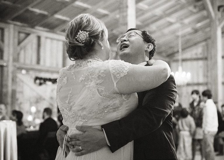 bride and groom first dance at barn wedding