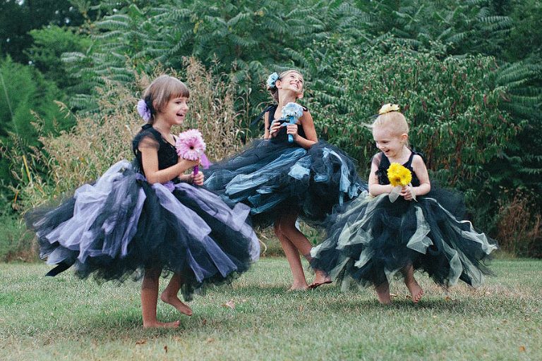flowergirls in black tulle dresses playing at an alabama wedding