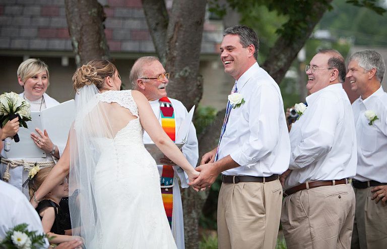 groom laughing at an outdoor talladega wedding