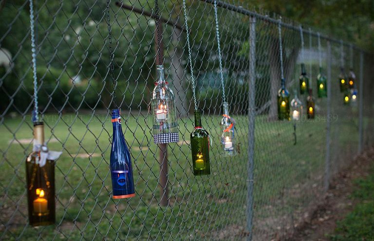 wine bottle candle holders at an outdoor alabama wedding reception