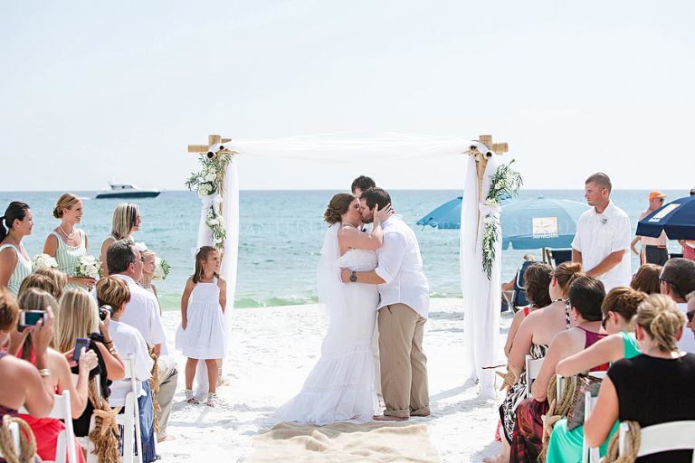 bride and groom kiss at destin beach wedding