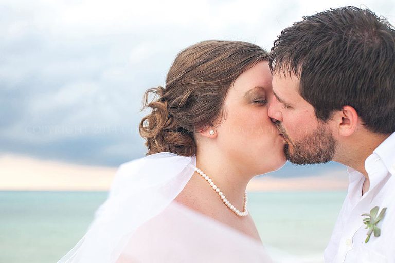 bride and groom kiss at sunset sandestin wedding