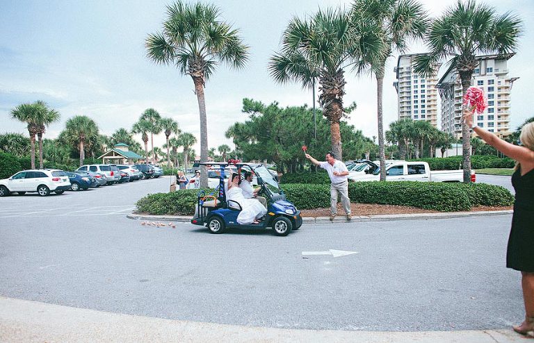 bride and groom leave in golf cart from sandestin wedding