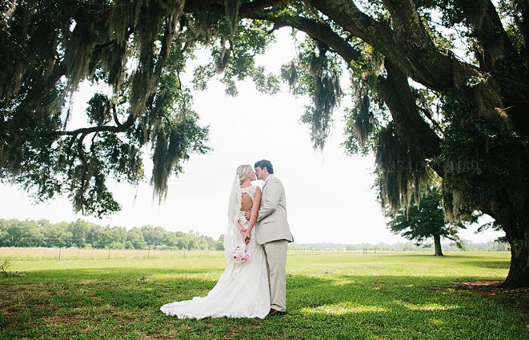 bride and groom under oak tree at pike road wedding
