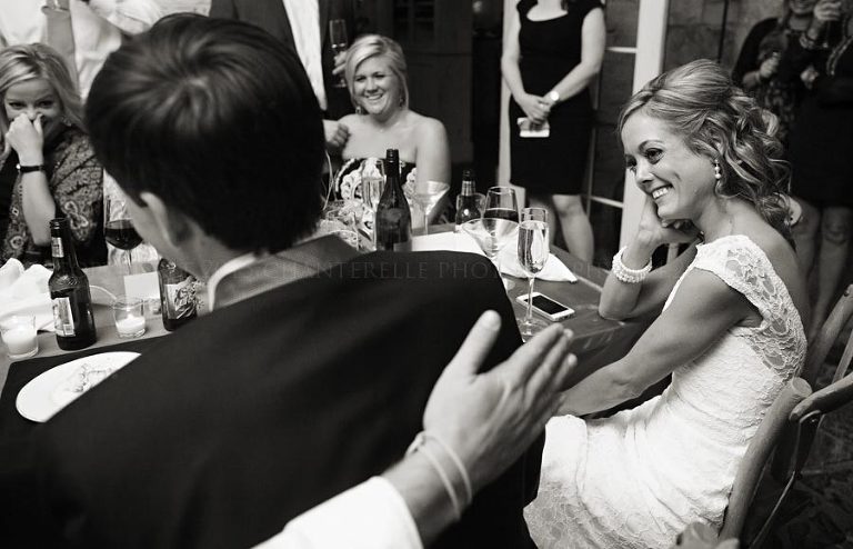 bride laughing at groom at auburn wedding reception