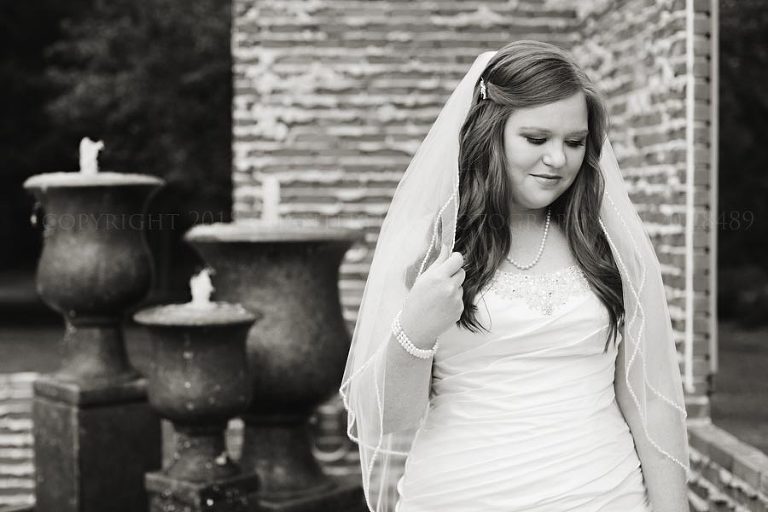 black and white bridal portrait with fountain