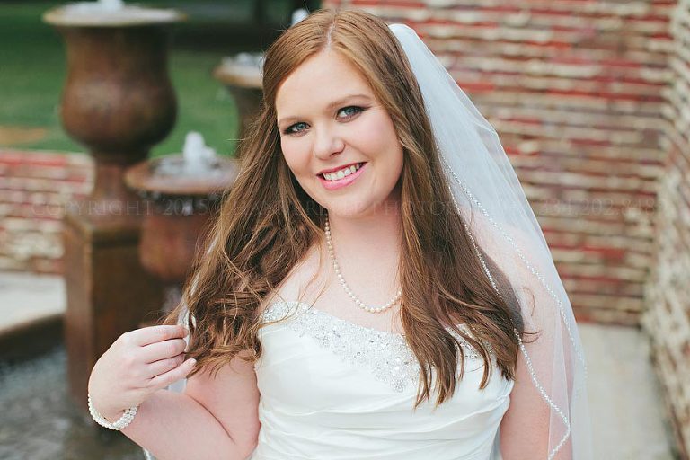 bride at fountain with brick background