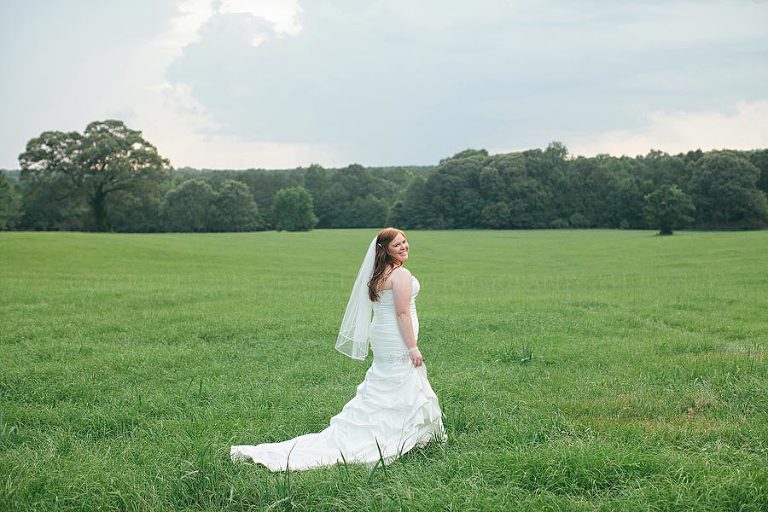bride in green field in alabama