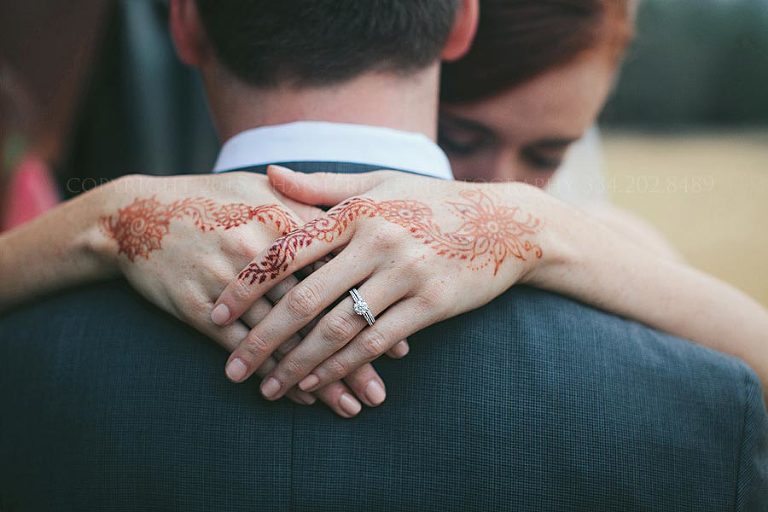 bride with mendhi on hands at auburn wedding