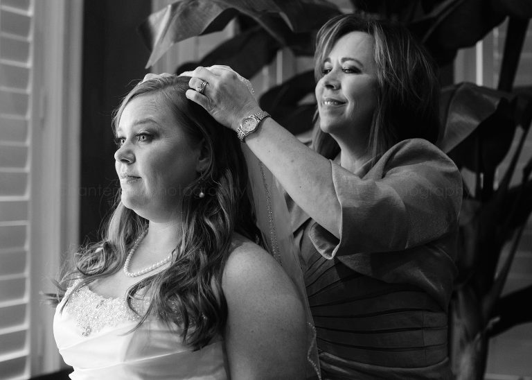 mother of the bride attaching veil at alabama wedding