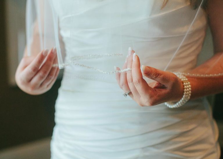 bride adjusting veil at southern wedding